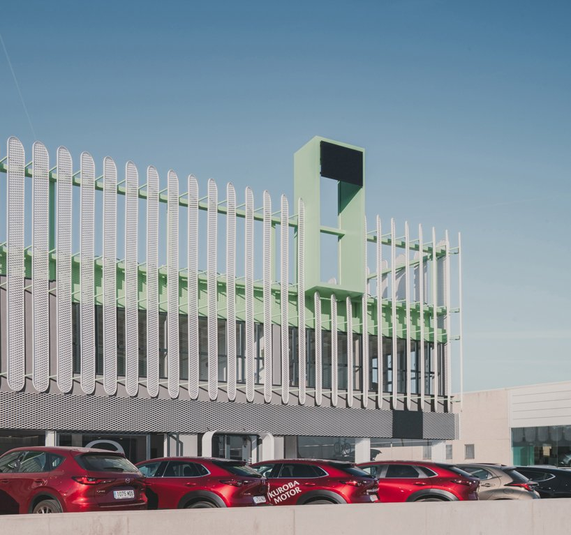 OOIIO wraps reused madrid auto center in permeable skin of vertical metal slats - 2