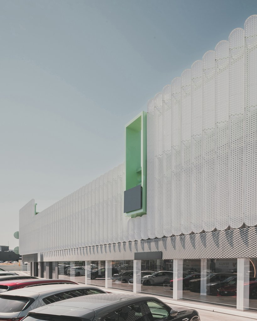 OOIIO wraps reused madrid auto center in permeable skin of vertical metal slats - 5