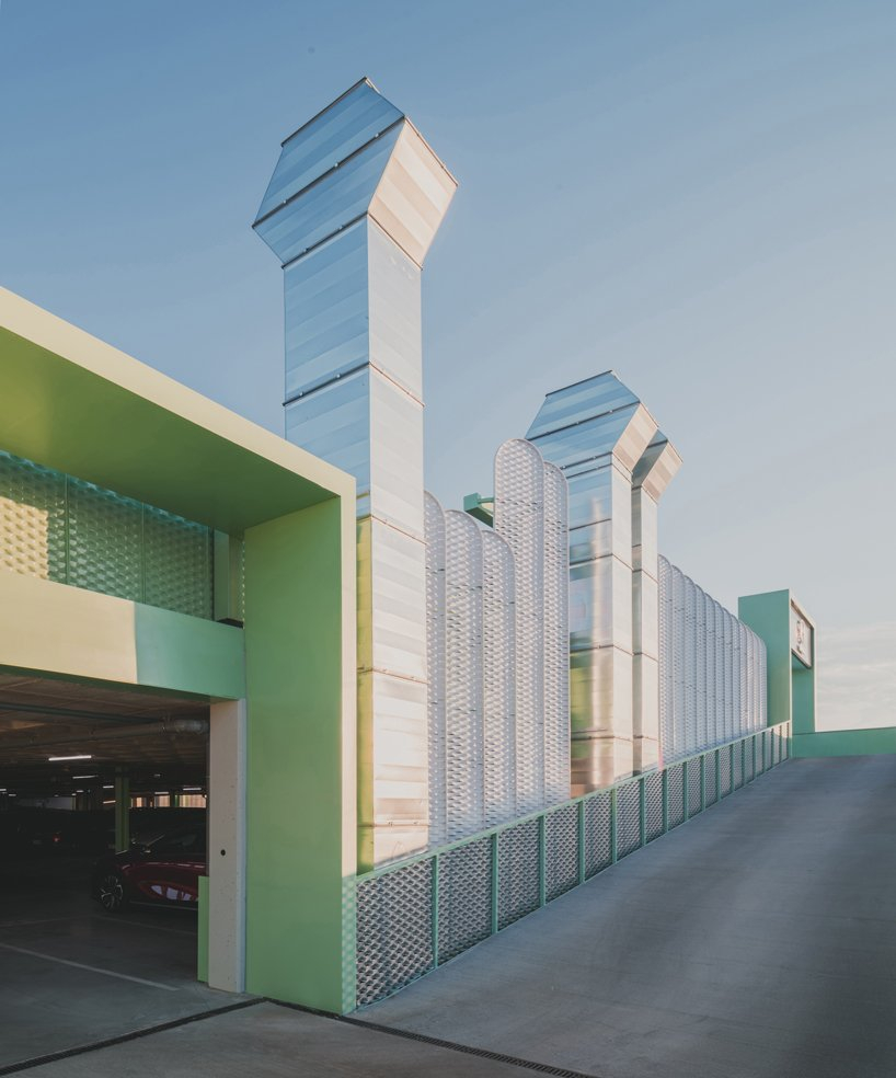 OOIIO wraps reused madrid auto center in permeable skin of vertical metal slats - 3