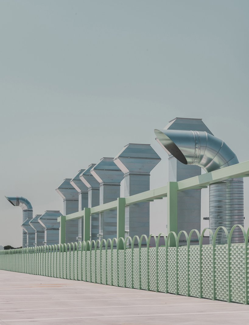 OOIIO wraps reused madrid auto center in permeable skin of vertical metal slats - 4