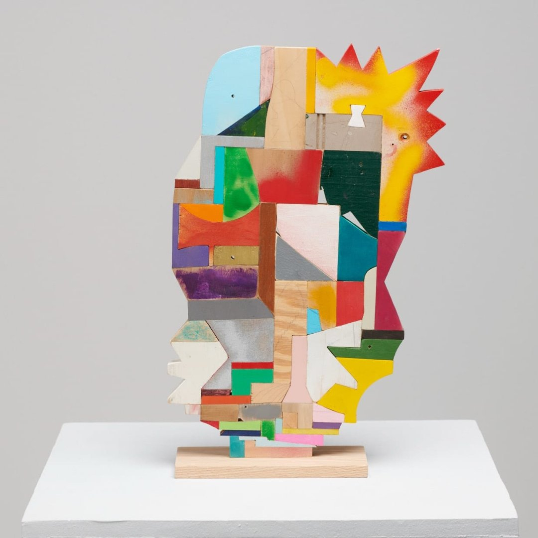 a small abstract wooden sculpture painted in vibrant colors by damien hoar de galvin