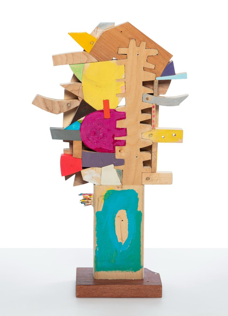 a small abstract wooden sculpture painted in vibrant colors by damien hoar de galvin