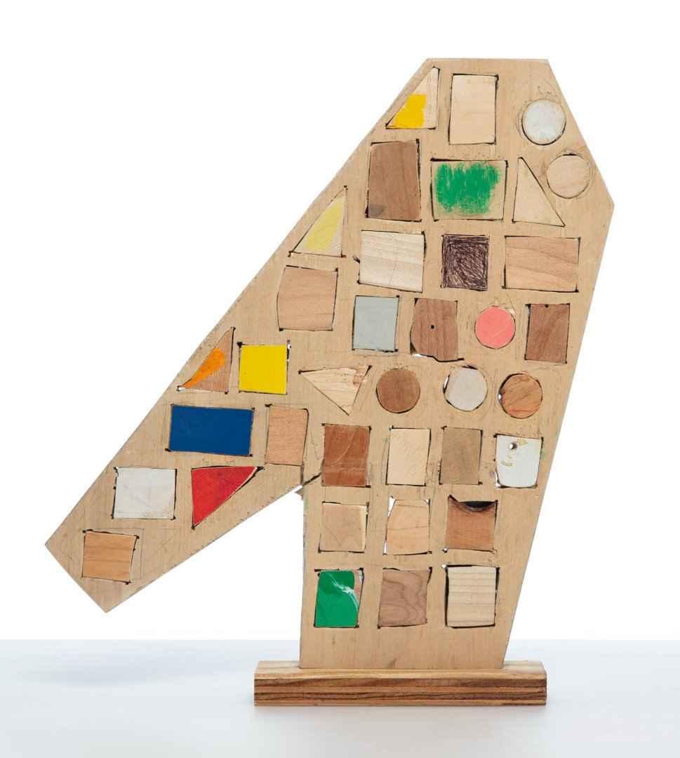 a small abstract wooden sculpture painted in vibrant colors by damien hoar de galvin